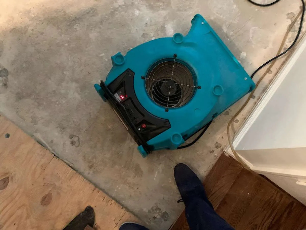 Air mover drying subfloor during Commercial Water Damage Restoration in Oakleaf Plantation